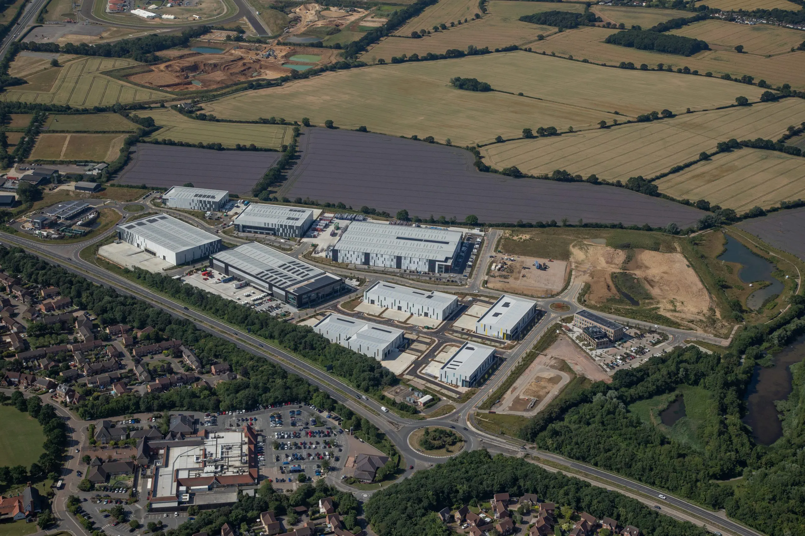 An aerial photograph of a collection of buildings next to a series of roads.